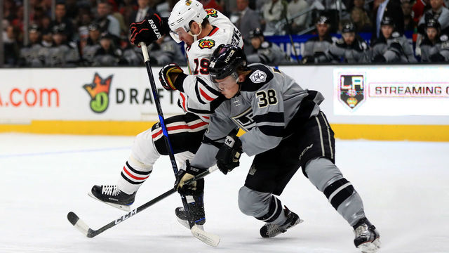 LOS ANGELES, CA - APRIL 08: Jonathan Toews #19 of the Chicago Blackhawks is pushed off the puck by Paul LaDue #38 of the Los Angeles Kings during the first period of a game at Staples Center on April 8, 2017 in Los Angeles, California.