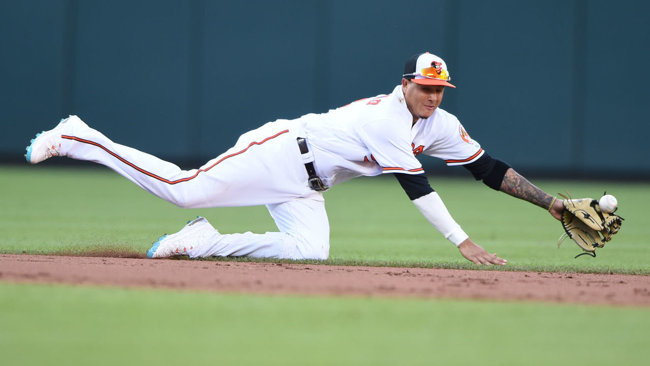 BALTIMORE, MD - JULY 09: Manny Machado #13 of the Baltimore Orioles can not get a ball hit by Miguel Andujar #41 (not pictured) of the New York Yankees in the ninth inning during a game one of a doubleheader baseball game at Oriole Park at Camden Yards on July 9, 2018 in Baltimore, Maryland.