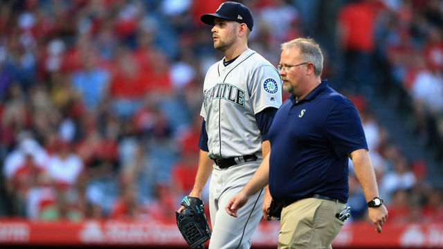 ANAHEIM, CA - JULY 12: James Paxton #65 of the Seattle Mariners leaves the game after allowing two homeruns during the first inning of a game against the Los Angeles Angels of Anaheim at Angel Stadium on July 12, 2018 in Anaheim, California.