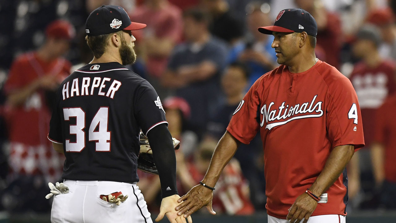 WASHINGTON, DC - MAY 04: Bryce Harper #34 of the Washington Nationals celebrates with manager Dave Martinez #4 after the Nationals defeated the Philadelphia Phillies 7-3 at Nationals Park on May 4, 2018 in Washington, DC.