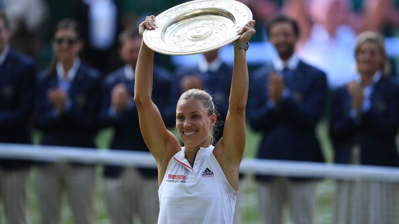 Germany's Angelique Kerber poses with the winner's trophy, the Venus Rosewater Dish, after her women's singles final victory over US player Serena Williams on the twelfth day of the 2018 Wimbledon Championships at The All England Lawn Tennis Club in Wimbledon, southwest London, on July 14, 2018. - Kerber won the match 6-3, 6-3.