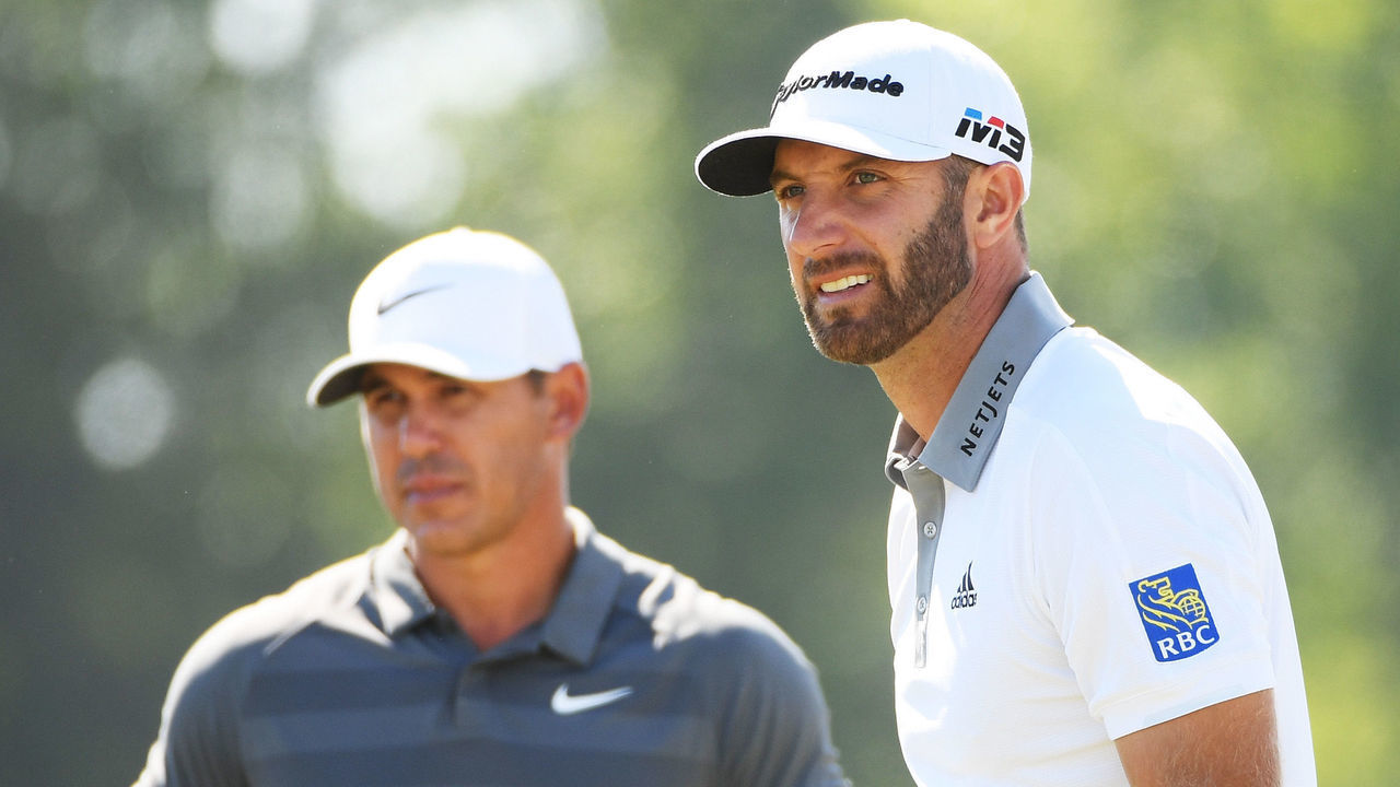SOUTHAMPTON, NY - JUNE 17: Brooks Koepka of the United States (L) and Dustin Johnson of the United States (R) look on from the ninth tee during the final round of the 2018 U.S. Open at Shinnecock Hills Golf Club on June 17, 2018 in Southampton, New York.