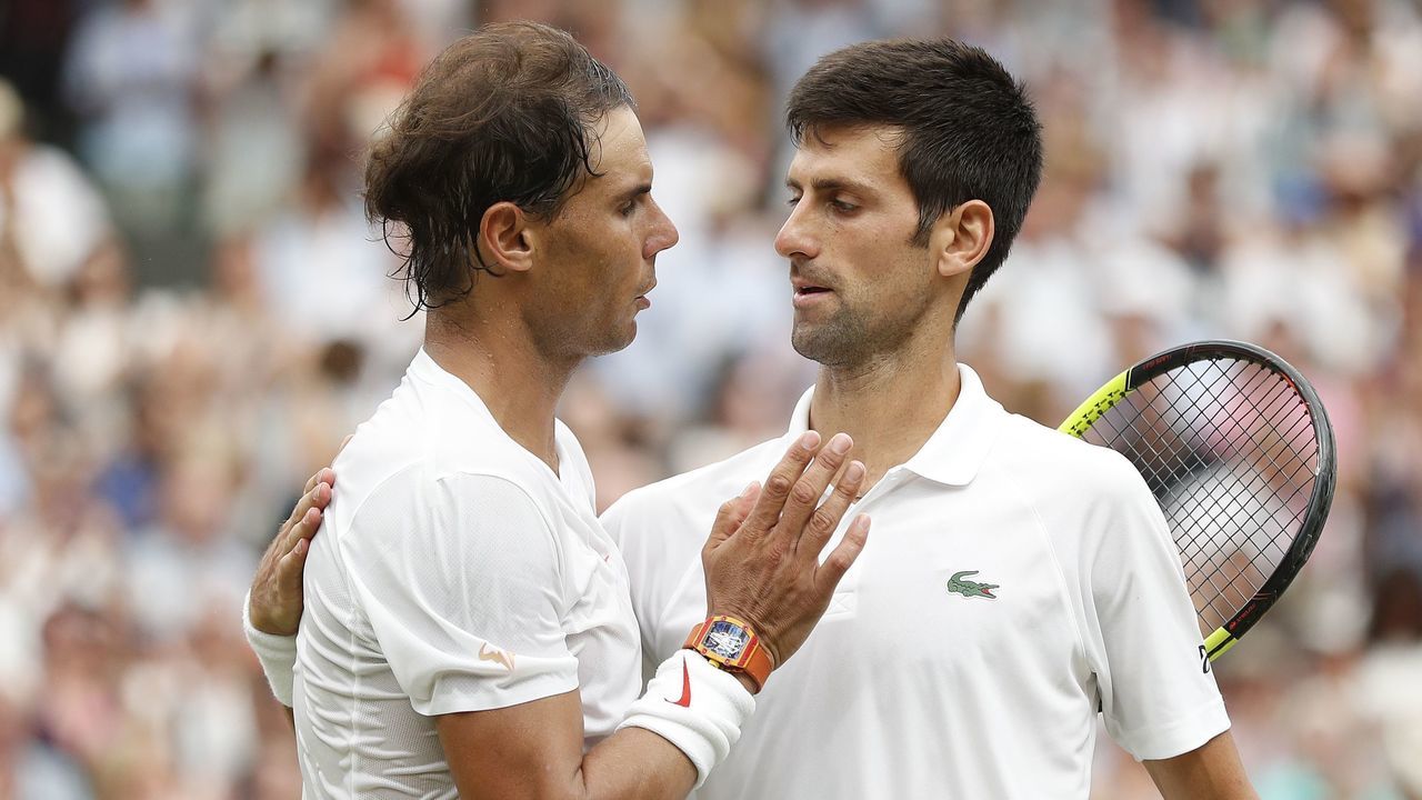 Serbia's Novak Djokovic (R) shakes hands after beating Spain's Rafael Nadal during the continuation of their men's singles semi-final match on the twelfth day of the 2018 Wimbledon Championships at The All England Lawn Tennis Club in Wimbledon, southwest London, on July 14, 2018. - Djokovic won the match 6-4, 3-6, 7-6, 3-6, 10-8.