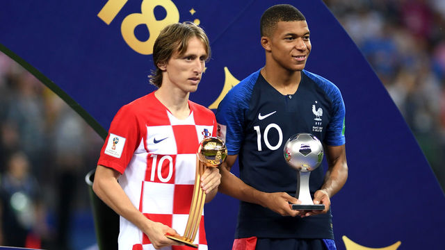 MOSCOW, RUSSIA - JULY 15: Luka Modric of Croatia and Kylian Mbappe of France pose respectively with their the adidas Golden Ball and with the FIFA Young Player award following the 2018 FIFA World Cup Final between France and Croatia at Luzhniki Stadium on July 15, 2018 in Moscow, Russia.