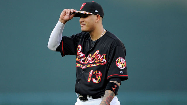 BALTIMORE, MD - JULY 14: Manny Machado #13 of the Baltimore Orioles warms up before the game against the Texas Rangers at Oriole Park at Camden Yards on July 14, 2018 in Baltimore, Maryland.