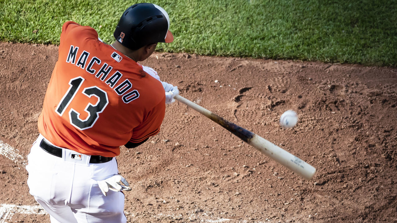 BALTIMORE, MD - JUNE 16: Manny Machado #13 of the Baltimore Orioles singles against the Miami Marlins during the seventh inning at Oriole Park at Camden Yards on June 16, 2018 in Baltimore, Maryland.