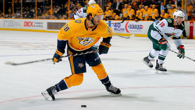 NASHVILLE, TN - MARCH 27: Ryan Hartman #38 of the Nashville Predators lines up a shot next to Jordan Greenway #18 of the Minnesota Wild during the first period at Bridgestone Arena on March 27, 2018 in Nashville, Tennessee.