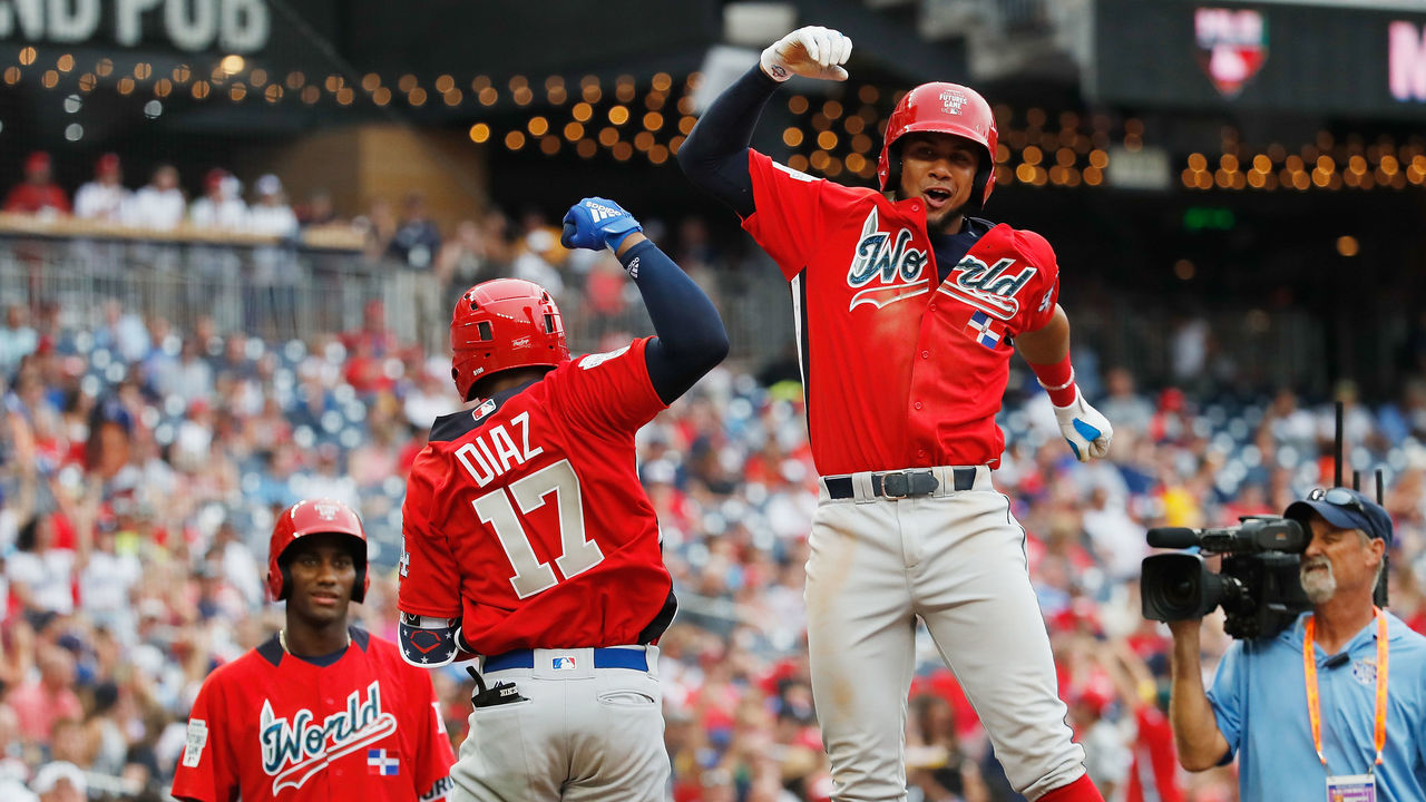 WASHINGTON, DC - JULY 15: Yusniel Diaz #17 of the Los Angeles Dodgers and the World Team celebrates after hitting a two-run home run with teammate Seuly Matias #25 of the Kansas City Royals and the World Team in the fifth inning against the U.S. Team during the SiriusXM All-Star Futures Game at Nationals Park on July 15, 2018 in Washington, DC.