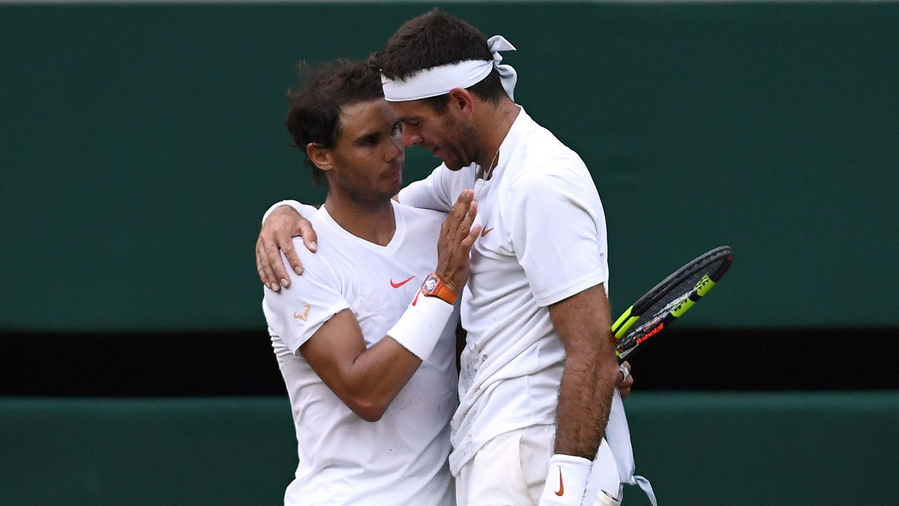 LONDON, ENGLAND - JULY 11: Rafael Nadal of Spain and Juan Martin Del Potro of Argentina embrace following their Men's Singles Quarter-Finals match on day nine of the Wimbledon Lawn Tennis Championships at All England Lawn Tennis and Croquet Club on July 11, 2018 in London, England. Nadal won the match 5-7, 7-6, 6-4, 4-6, 4-6 in 4hr 47min.