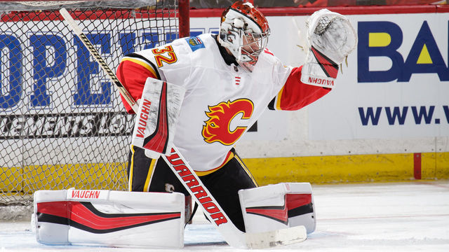 OTTAWA, ON - MARCH 9: Jon Gillies #32 of the Calgary Flames makes a save during warmups prior to a game against the Ottawa Senators at Canadian Tire Centre on March 9, 2018 in Ottawa, Ontario, Canada. *** Local Caption ***