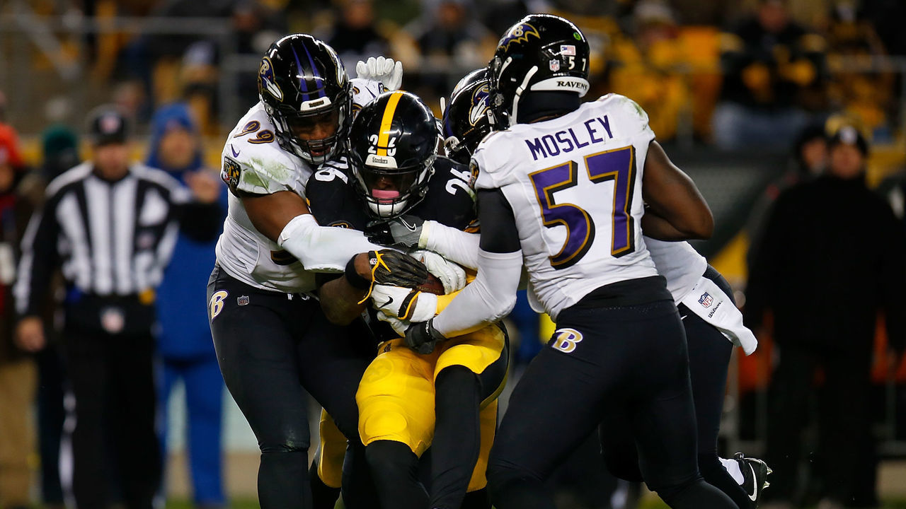 PITTSBURGH, PA - DECEMBER 10: Le'Veon Bell #26 of the Pittsburgh Steelers is gang tackled by the Baltimore Ravens in the second half during the game at Heinz Field on December 10, 2017 in Pittsburgh, Pennsylvania.