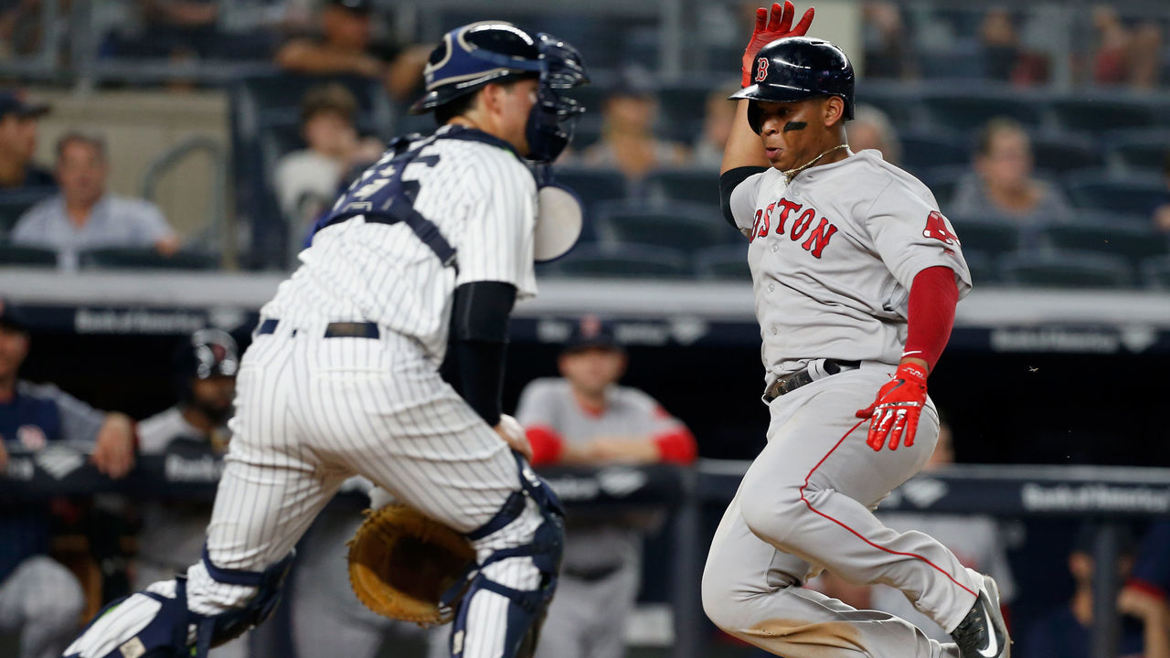 NEW YORK, NY - JUNE 30: Rafael Devers #11 of the Boston Red Sox scores a run in the ninth inning past Kyle Higashioka #66 of the New York Yankees at Yankee Stadium on June 30, 2018 in the Bronx borough of New York City.