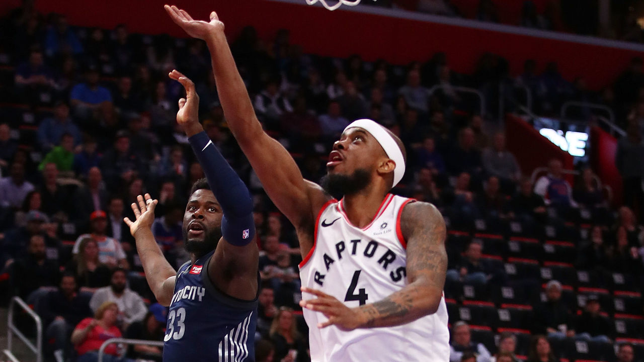DETROIT, MI - APRIL 09: Lorenzo Brown #4 of the Toronto Raptors gets to the basket next to James Ennis III #33 of the Detroit Pistons during the second half at Little Caesars Arena on April 9, 2018 in Detroit, Michigan. Toronto won the game 108-98.