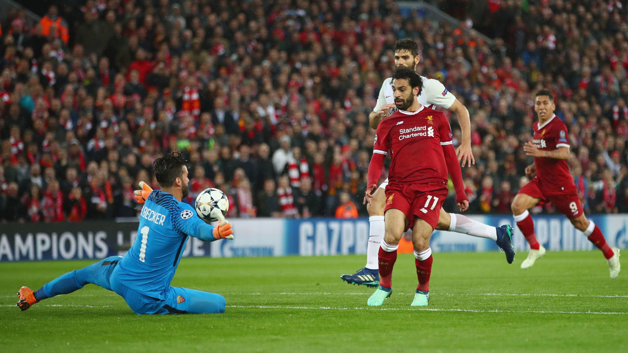 LIVERPOOL, ENGLAND - APRIL 24: Mohamed Salah of Liverpool scores his sides second goal past Alisson Becker of AS Roma during the UEFA Champions League Semi Final First Leg match between Liverpool and A.S. Roma at Anfield on April 24, 2018 in Liverpool, United Kingdom.