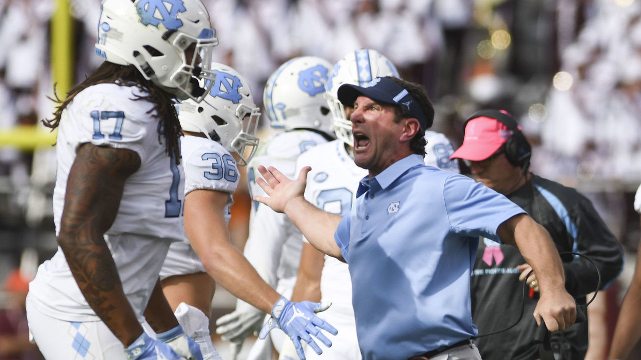 BLACKSBURG, VA - OCTOBER 21: Head coach Larry Fedora of the North Carolina Tar Heels reacts with linebacker Cole Holcomb #36 in the first half against the Virginia Tech Hokies at Lane Stadium on October 21, 2017 in Blacksburg, Virginia.