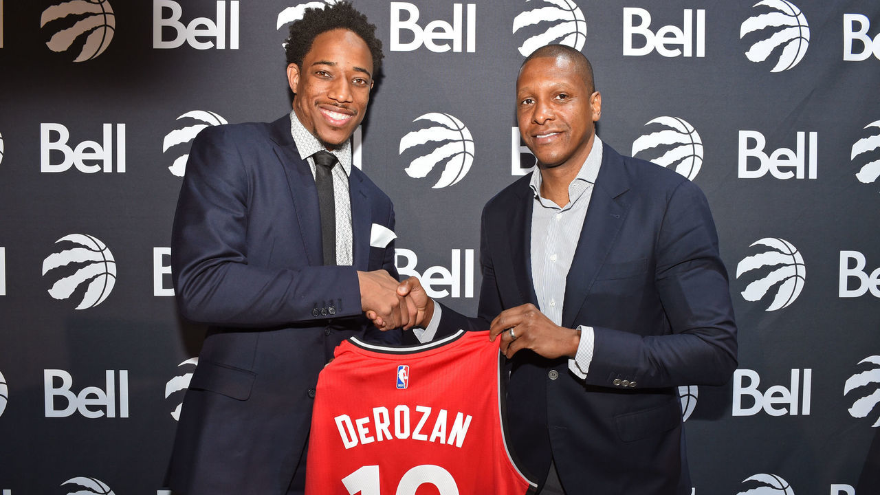 TORONTO, CANADA - JULY 14: DeMar DeRozan #10 and Masai Ujiri of the Toronto Raptors pose for a photo during a press conference after announcing his new deal on July 14, 2016 at the Real Sports Bar & Grill in Toronto, Ontario, Canada. Mandatory Copyright Notice: Copyright 2016 NBAE