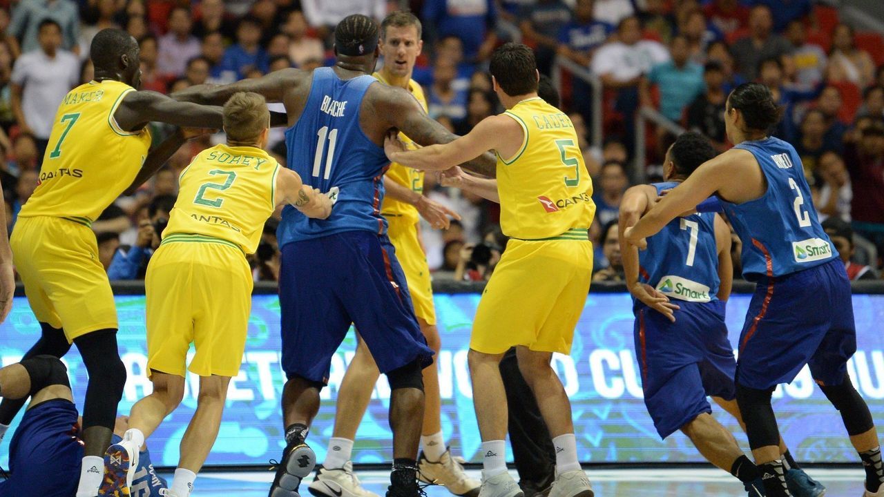 Philippine (blue) and Australian (yellow) players engage in a brawl during their FIBA World Cup Asian qualifier game at the Philippine arena in Bocaue town, Bulacan province, north of Manila on July 2, 2018. - Australia won by default 89-53.