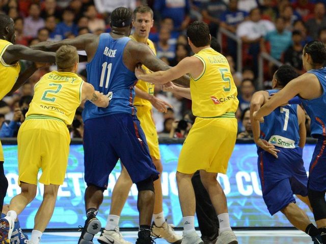 Philippine (blue) and Australian (yellow) players engage in a brawl during their FIBA World Cup Asian qualifier game at the Philippine arena in Bocaue town, Bulacan province, north of Manila on July 2, 2018. - Australia won by default 89-53.