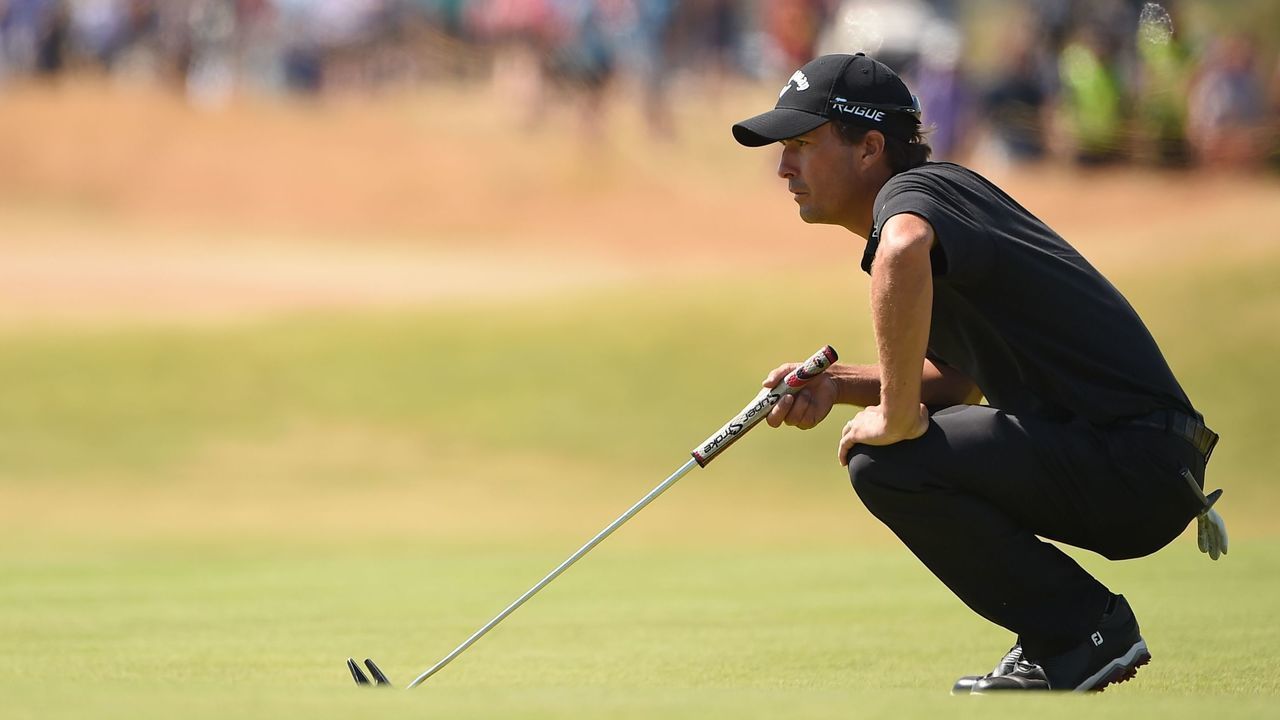 US golfer Kevin Kisner lines up a putt on the 16th green during his first round on day one of The 147th Open golf Championship at Carnoustie, Scotland on July 19, 2018.