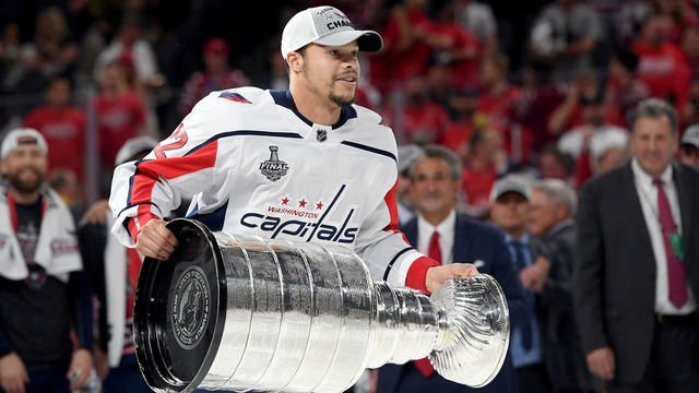 LAS VEGAS, NV - JUNE 07: Madison Bowey #22 of the Washington Capitals hoists the Stanley Cup after his team defeated the Vegas Golden Knights 4-3 in Game Five of the 2018 NHL Stanley Cup Final at T-Mobile Arena on June 7, 2018 in Las Vegas, Nevada.