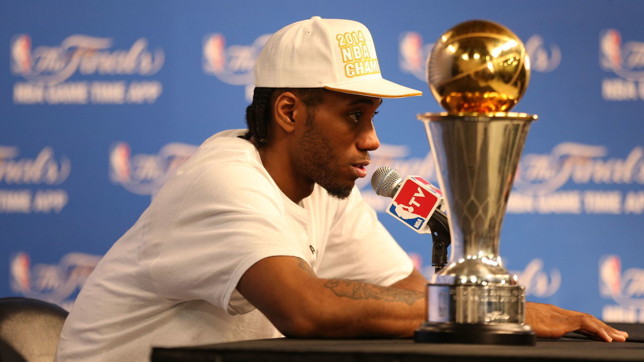 SAN ANTONIO, TX - JUNE 15: Kawhi Leonard #2 of the San Antonio Spurs winner of the Bill Russell NBA Finals Most Valuable Player Award addresses the media after winning the Larry O'Brien Trophy in Game Five of the 2014 NBA Finals against the Miami Heat at AT&T Center on June 15, 2014 in San Antonio, Texas. NOTE TO USER: User expressly acknowledges and agrees that, by downloading and/or using this photograph, user is consenting to the terms and conditions of the Getty Images License Agreement. Mandatory Copyright Notice: Copyright 2014 NBAE