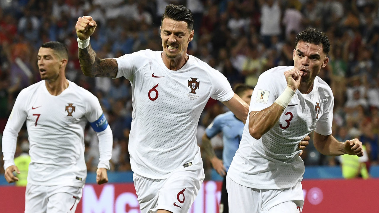 TOPSHOT - Portugal's defender Pepe (R) celebrates with Portugal's defender Jose Fonte (C) after scoring the equalizer during the Russia 2018 World Cup round of 16 football match between Uruguay and Portugal at the Fisht Stadium in Sochi on June 30, 2018.