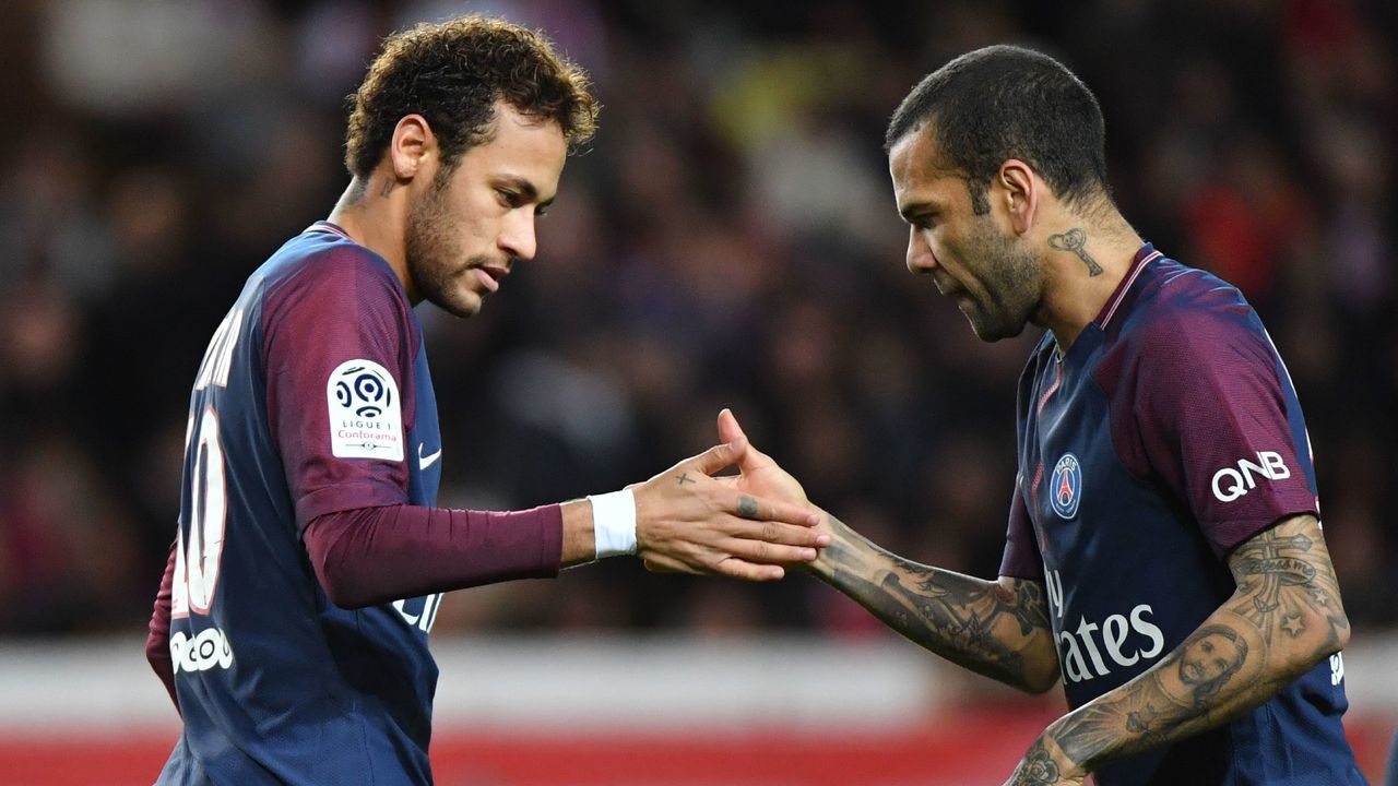Paris Saint-Germain's Brazilian defender Dani Alves (R) congratulates Paris Saint-Germain's Brazilian forward Neymar after he scored a penalty kick during the French L1 football match between Monaco and Paris Saint-Germain (PSG) at the Louis II stadium, in Monaco, on November 26, 2017. / AFP PHOTO / Yann COATSALIOU