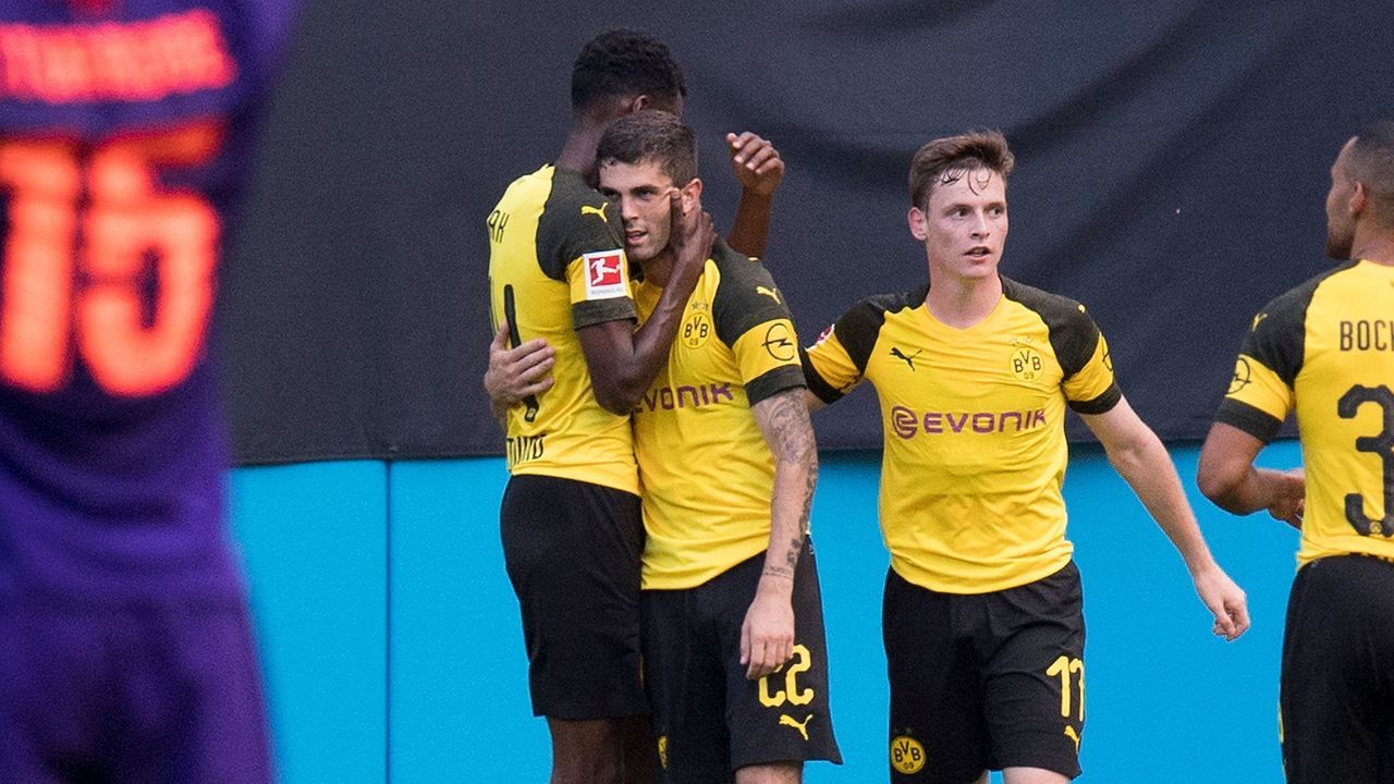 Borussia Dortmund's Christian Pulisic (C) celebrates his second goal against Liverpool with teammates during the 2018 International Champions Cup at Bank of America Stadium in Charlotte, North Carolina, on July 22, 2018.