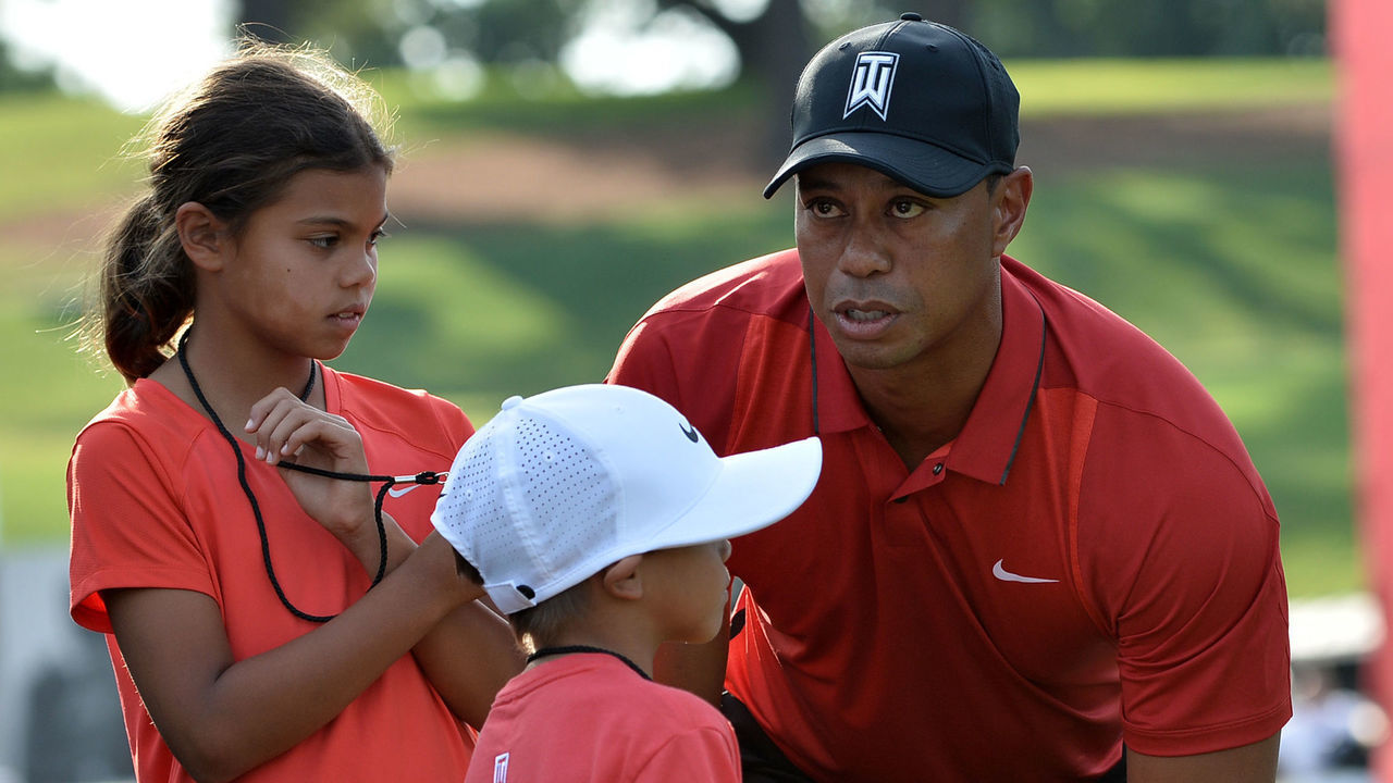 Tiger Woods stands with his children Sam(L) and Charlie after the Quicken Loans National at Congressional Country Club in Bethesda, Maryland on on June 26, 2016. / AFP / ANDREW CABALLERO-REYNOLDS