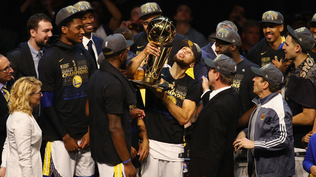 CLEVELAND, OH - JUNE 08: Stephen Curry #30 of the Golden State Warriors celebrates with the Larry O'Brien Trophy after defeating the Cleveland Cavaliers during Game Four of the 2018 NBA Finals at Quicken Loans Arena on June 8, 2018 in Cleveland, Ohio. The Warriors defeated the Cavaliers 108-85 to win the 2018 NBA Finals.