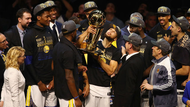 CLEVELAND, OH - JUNE 08: Stephen Curry #30 of the Golden State Warriors celebrates with the Larry O'Brien Trophy after defeating the Cleveland Cavaliers during Game Four of the 2018 NBA Finals at Quicken Loans Arena on June 8, 2018 in Cleveland, Ohio. The Warriors defeated the Cavaliers 108-85 to win the 2018 NBA Finals.