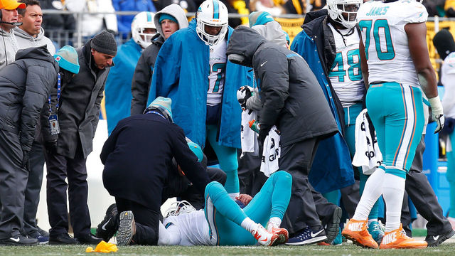 PITTSBURGH, PA - JANUARY 08: Matt Moore #8 of the Miami Dolphins is looked at by trainers after a hard hit from Bud Dupree #48 of the Pittsburgh Steelers in the first half during the AFC Wild Card game at Heinz Field on January 8, 2017 in Pittsburgh, Pennsylvania.