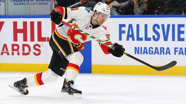 BUFFALO, NY - MARCH 7: Brett Kulak #61 of the Calgary Flames takes a shot against the Buffalo Sabres during the third period at KeyBank Center on March 7, 2018 in Buffalo, New York.