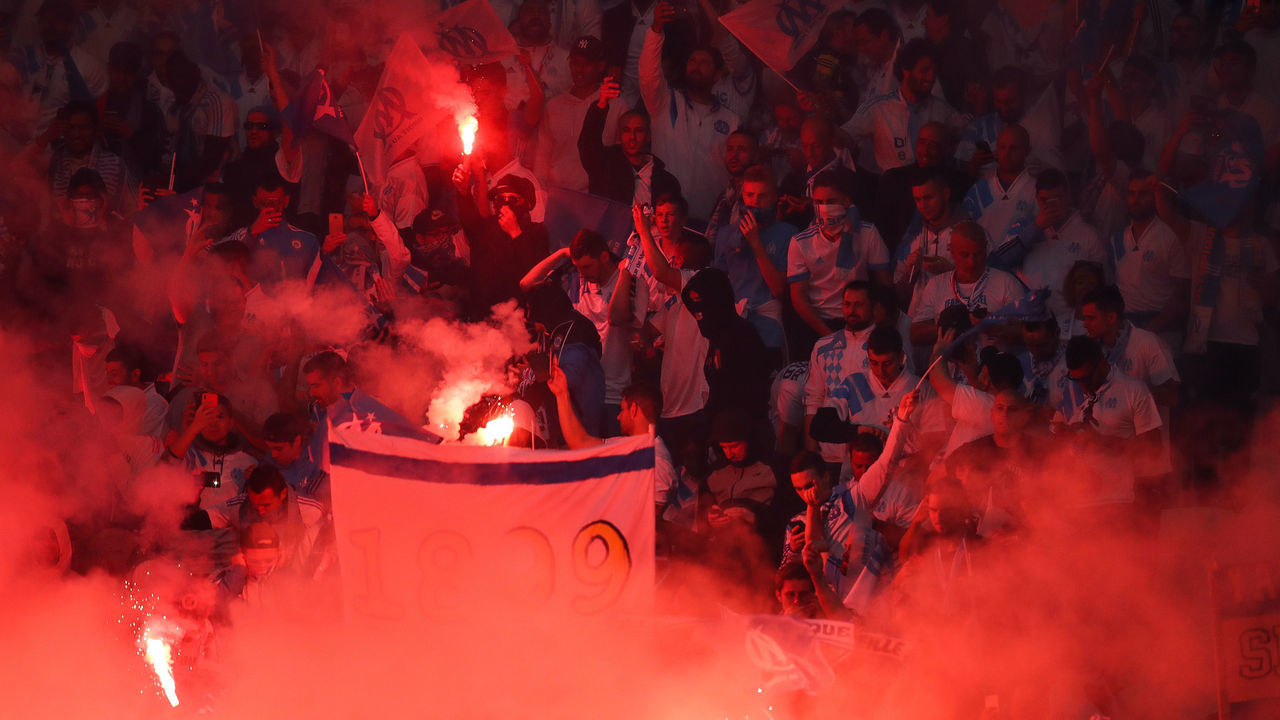 LYON, FRANCE - MAY 16: Fans of Marseille battle using fireworks prior to the UEFA Europa League Final between Olympique de Marseille and Club Atletico de Madrid at Stade de Lyon on May 16, 2018 in Lyon, France.