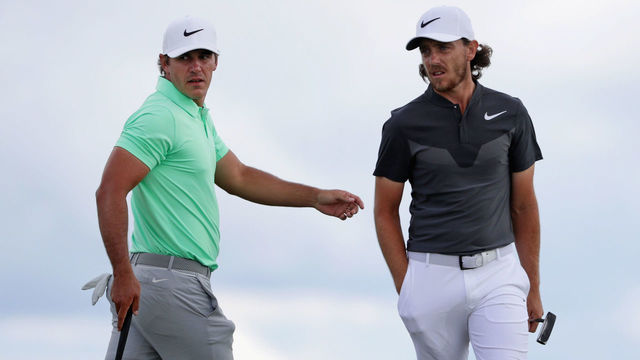 HARTFORD, WI - JUNE 18: Brooks Koepka of the United States (L) and Tommy Fleetwood of England walk across the eighth green during the final round of the 2017 U.S. Open at Erin Hills on June 18, 2017 in Hartford, Wisconsin.