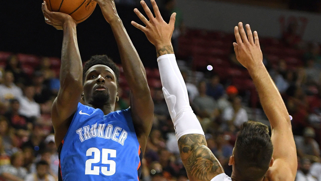 LAS VEGAS, NV - JULY 06: Daniel Hamilton #25 of the Oklahoma City Thunder shoots against Willy Hernangomez #41 of the Charlotte Hornets during the 2018 NBA Summer League at the Thomas & Mack Center on July 6, 2018 in Las Vegas, Nevada.