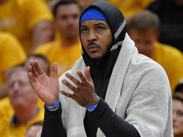 SALT LAKE CITY, UT - APRIL 21: Carmelo Anthony #7 of the Oklahoma City Thunder cheers from the bench in the first half during Game Three of Round One of the 2018 NBA Playoffs against the Utah Jazz at Vivint Smart Home Arena on April 21, 2018 in Salt Lake City, Utah.