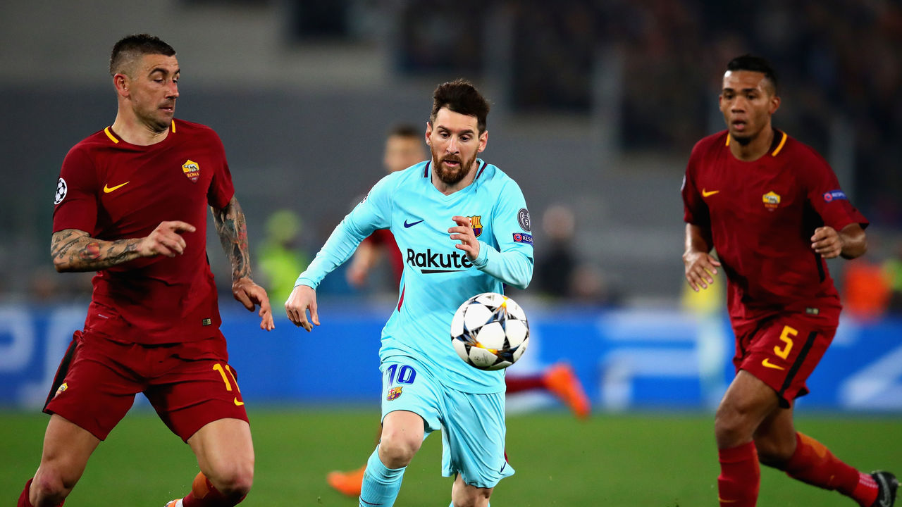 ROME, ITALY - APRIL 10: Lionel Messi of FC Barcelona is challenged by Aleksandar Kolarov of AS Roma during the UEFA Champions League Quarter Final, second leg match between AS Roma and FC Barcelona at Stadio Olimpico on April 10, 2018 in Rome, Italy.