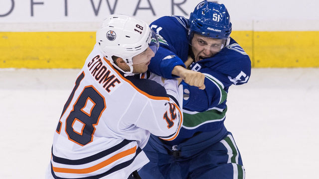 VANCOUVER, BC - OCTOBER 7: Troy Stecher #51 of the Vancouver Canucks throws a right hand during a fight against Ryan Strome #18 of the Edmonton Oilers in NHL action on October, 7, 2017 at Rogers Arena in Vancouver, British Columbia, Canada.