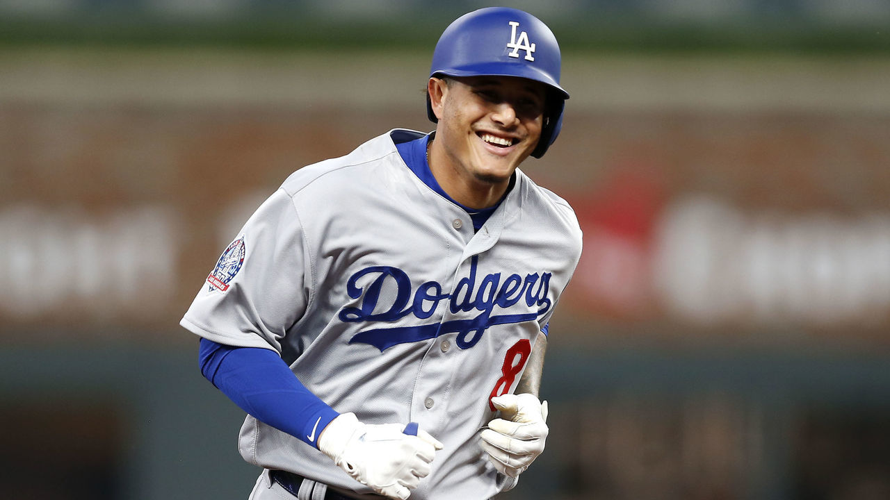 ATLANTA, GA - JULY 26: Third baseman Manny Machado #8 of the Los Angeles Dodgers smiles while running the bases after hitting a solo home run in the sixth inning during the game against the Atlanta Braves at SunTrust Park on July 26, 2018 in Atlanta, Georgia.