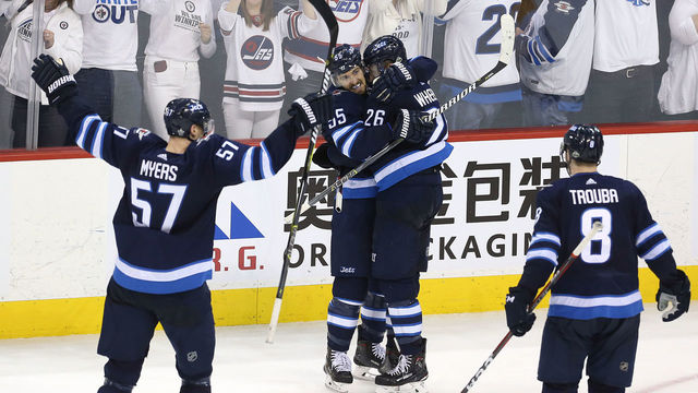 WINNIPEG, MANITOBA - MAY 1: Mark Scheifele #55 congratulates Blake Wheeler #26 of the Winnipeg Jets on his empty-net goal against the Nashville Predators in Game Three of the Western Conference Second Round during the 2018 NHL Stanley Cup Playoffs on May 1, 2018 at Bell MTS Place in Winnipeg, Manitoba, Canada.