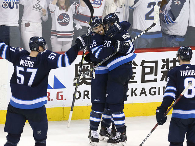 WINNIPEG, MANITOBA - MAY 1: Mark Scheifele #55 congratulates Blake Wheeler #26 of the Winnipeg Jets on his empty-net goal against the Nashville Predators in Game Three of the Western Conference Second Round during the 2018 NHL Stanley Cup Playoffs on May 1, 2018 at Bell MTS Place in Winnipeg, Manitoba, Canada.