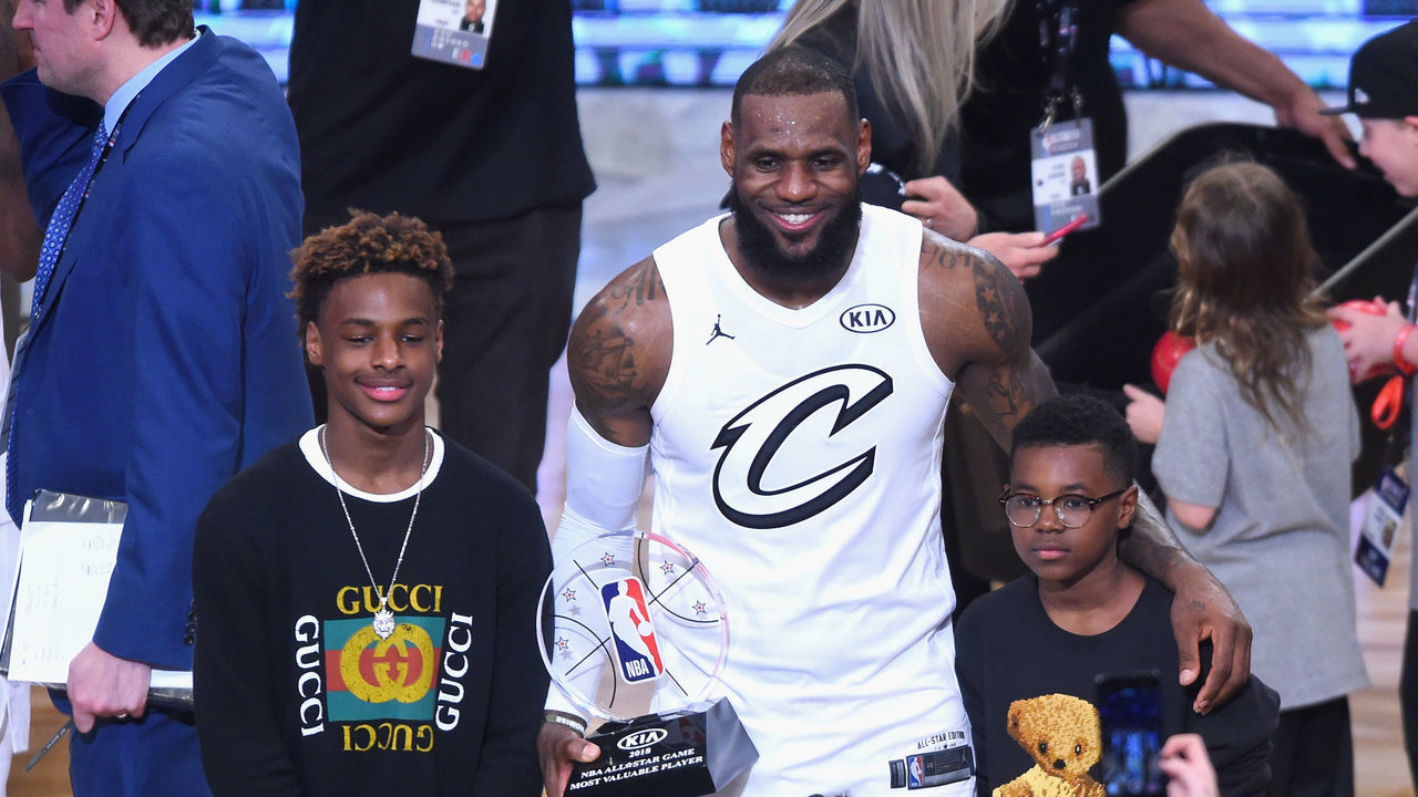 LOS ANGELES, CA - FEBRUARY 18: (L-R) LeBron James Jr., LeBron James #23, Zhuri James and Bryce Maximus James pose for a photo with the All-Star Game MVP trophy during the NBA All-Star Game 2018 at Staples Center on February 18, 2018 in Los Angeles, California.