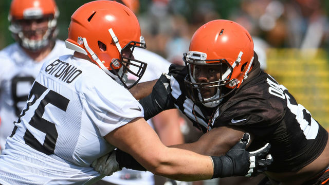 BEREA, OH - JULY 26, 2018: Defensive lineman Larry Ogunjobi #65 and offensive lineman Joel Bitonio #75 of the Cleveland Browns engage during a training camp practice on July 26, 2018 at the Cleveland Browns training facility in Berea, Ohio. (Photo by: 2018 Nick Cammett/Diamond Images/Getty Images)
