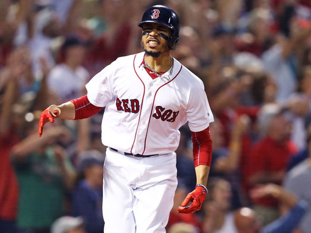 BOSTON, MA - JULY 12: Mookie Betts #50 of the Boston Red Sox celebrates after hitting a grand slam against the Toronto Blue Jays during the fourth inning at Fenway Park on July 12, 2018 in Boston, Massachusetts.