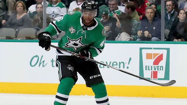 DALLAS, TX - DECEMBER 21: Gemel Smith #46 of the Dallas Stars battles for the puck against Nick Schmaltz #8 of the Chicago Blackhawks in the first period at American Airlines Center on December 21, 2017 in Dallas, Texas.