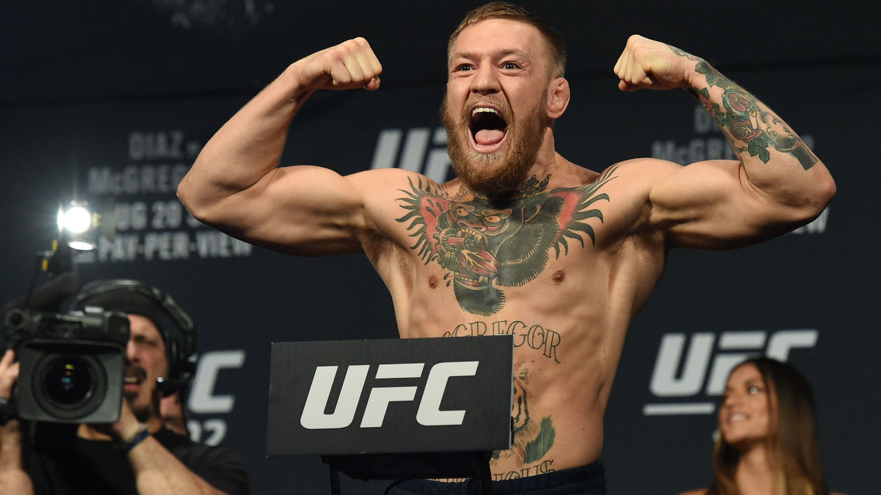LAS VEGAS, NV - AUGUST 19: UFC featherweight champion Conor McGregor poses on the scale during his weigh-in for UFC 202 at MGM Grand Conference Center on August 19, 2016 in Las Vegas, Nevada. McGregor will meet Nate Diaz in a welterweight rematch on August 20, 2016, at T-Mobile Arena in Las Vegas.