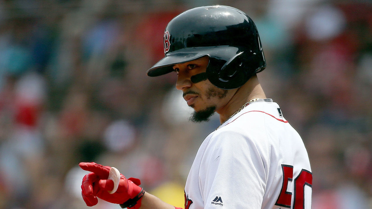 BOSTON, MA - JULY 29: Mookie Betts #50 of the Boston Red Sox gestures before batting against the Minnesota Twins in the first inning at Fenway Park on July 29, 2018 in Boston, Massachusetts.