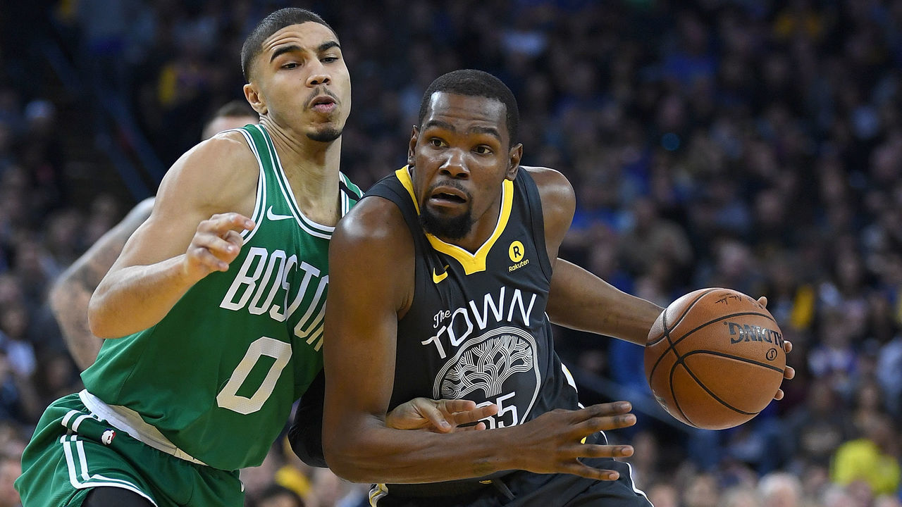 OAKLAND, CA - JANUARY 27: Kevin Durant #35 of the Golden State Warriors drives on Jayson Tatum #0 of the Boston Celtics during an NBA basketball game at ORACLE Arena on January 27, 2018 in Oakland, California.