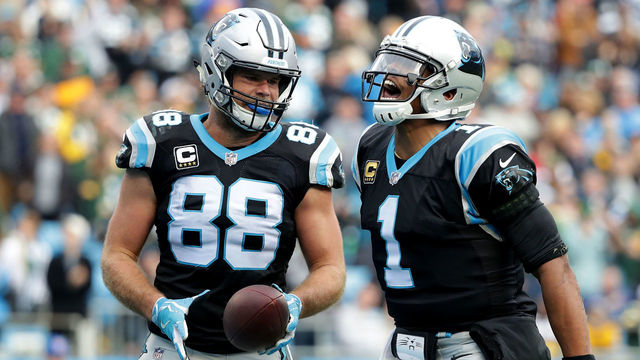 CHARLOTTE, NC - DECEMBER 17: Greg Olsen #88 celebrates with teammate Cam Newton #1 of the Carolina Panthers after a touchdown against the Green Bay Packers in the third quarter during their game at Bank of America Stadium on December 17, 2017 in Charlotte, North Carolina.